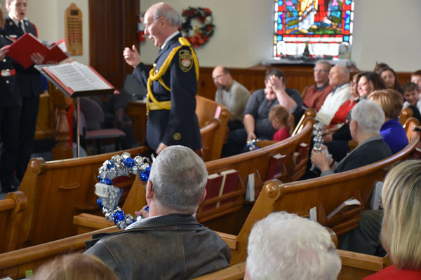 Chorus Director Geoff Linklater conducting the Chorus and ready to bring in the wreath bell ringers in the audience.